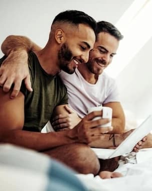 Parents and their baby researching top surrogacy agencies online